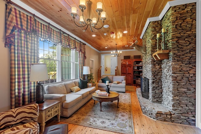 living room with an inviting chandelier, light hardwood / wood-style flooring, ornamental molding, a fireplace, and wood ceiling