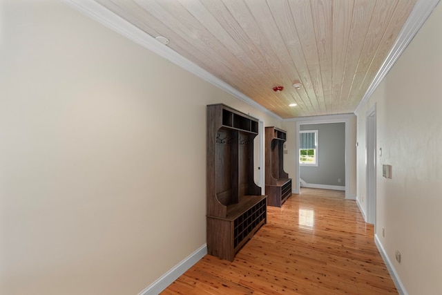 corridor with light wood-type flooring, wood ceiling, and ornamental molding