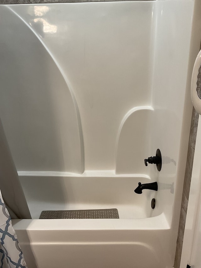 interior details with shower / tub combo