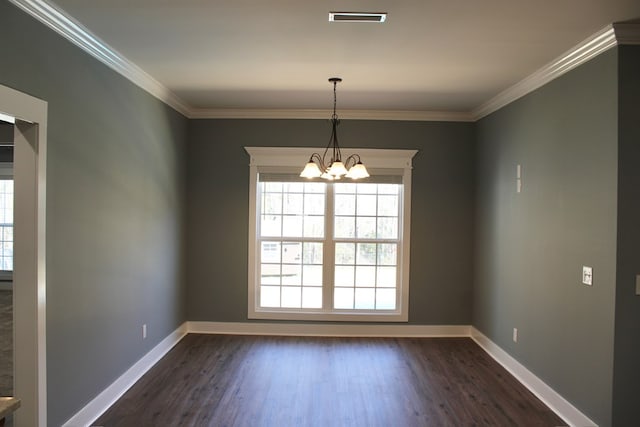 empty room with visible vents, baseboards, dark wood finished floors, and crown molding