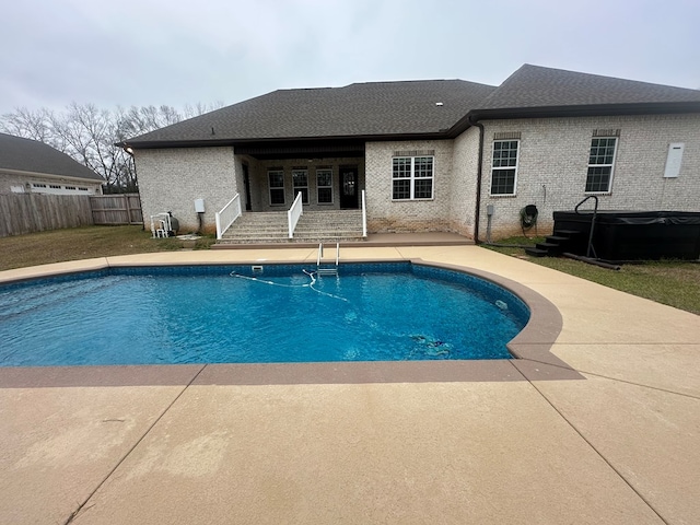 view of swimming pool featuring a fenced in pool, fence, and a patio area