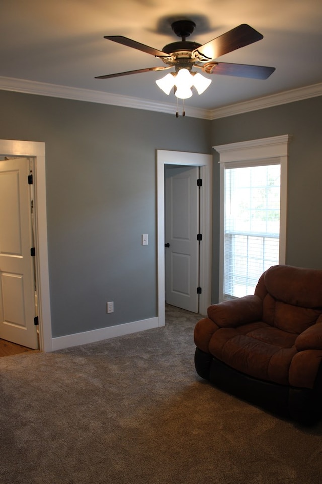 living area with carpet flooring, baseboards, ceiling fan, and crown molding