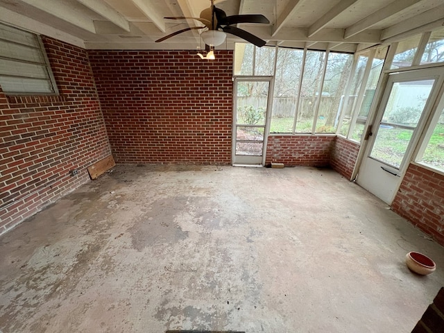 unfurnished sunroom with ceiling fan