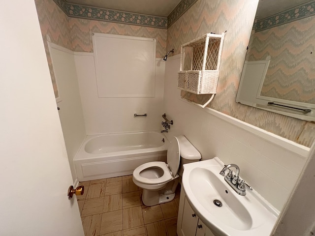 full bathroom featuring toilet, vanity, and shower / washtub combination