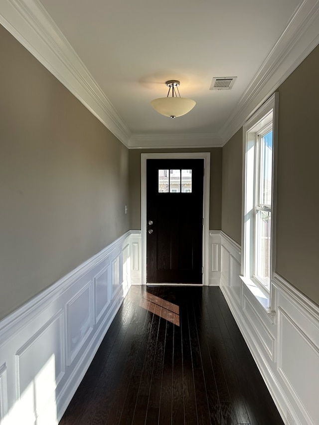 entrance foyer featuring dark hardwood / wood-style flooring and crown molding