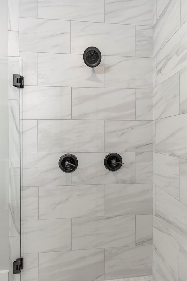 full bath with a tile shower