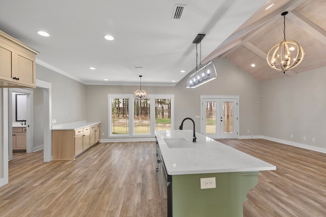 kitchen featuring french doors, vaulted ceiling with beams, visible vents, a sink, and a chandelier