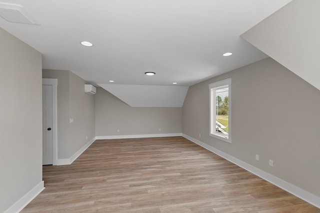 bonus room with visible vents, baseboards, lofted ceiling, light wood-style flooring, and recessed lighting