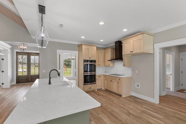 kitchen with wall chimney exhaust hood, black electric cooktop, french doors, double oven, and light brown cabinets