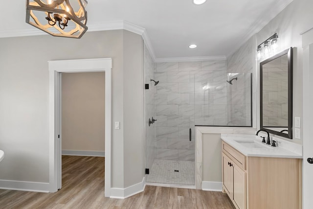 bathroom featuring a shower stall, crown molding, and wood finished floors