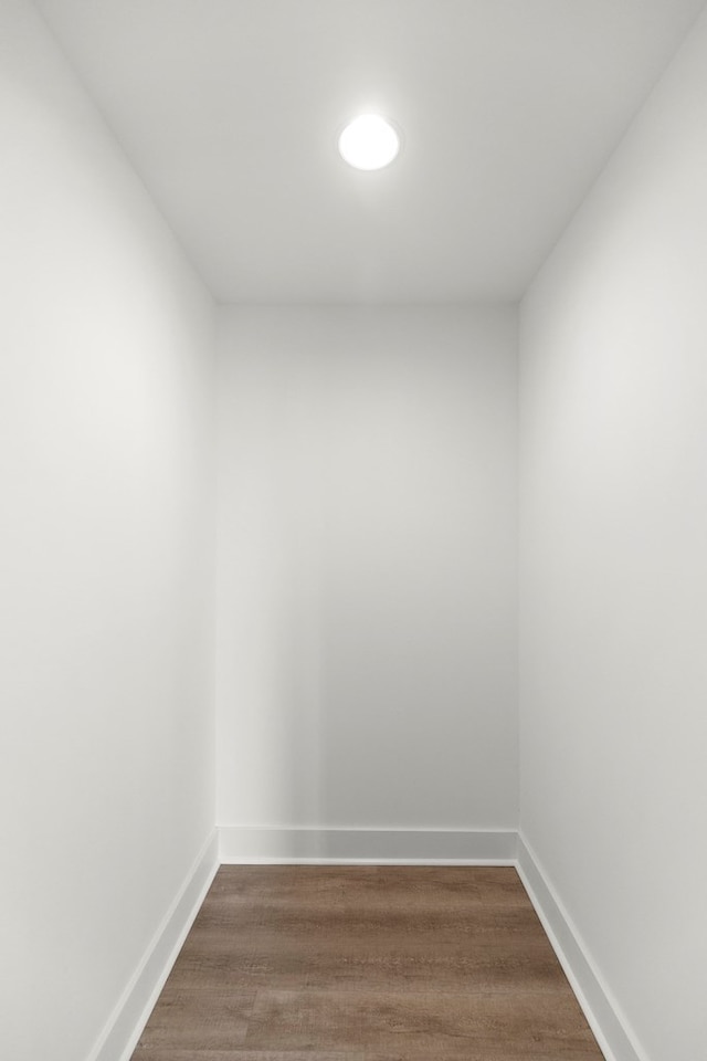 empty room with dark wood-style floors and baseboards