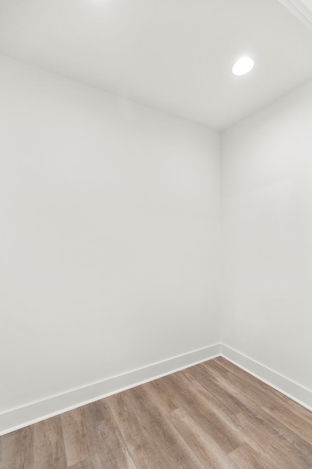 unfurnished room with light wood-style flooring and baseboards