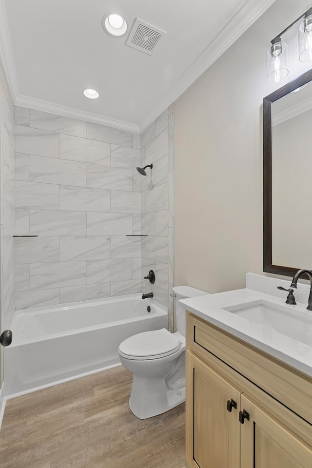 full bath with bathtub / shower combination, toilet, wood finished floors, visible vents, and ornamental molding