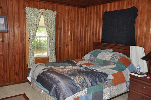 bedroom featuring wood walls and light colored carpet