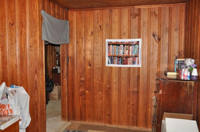 corridor with wood walls and light carpet