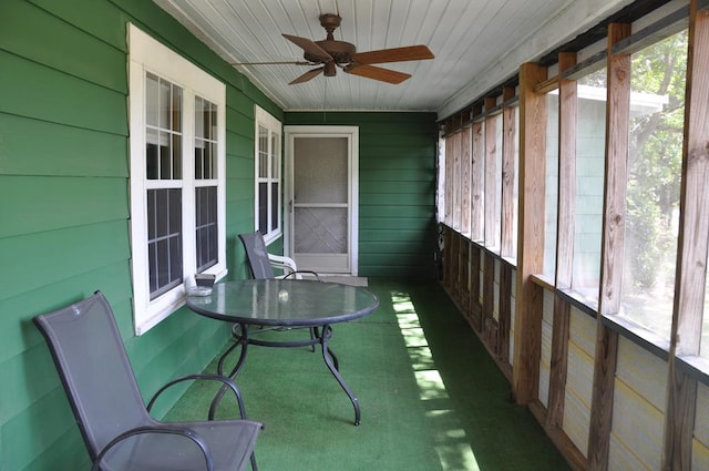 unfurnished sunroom with ceiling fan and wood ceiling