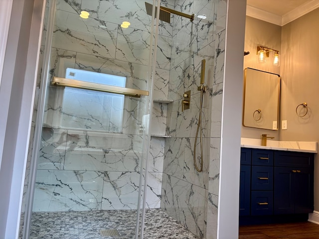 bathroom with vanity, a shower with shower door, and ornamental molding