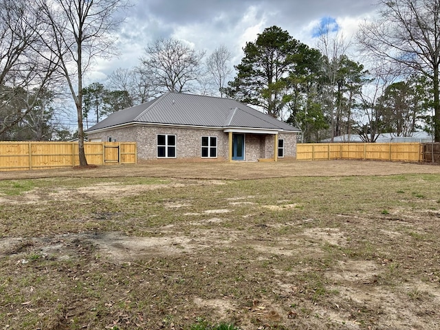 rear view of house with a lawn