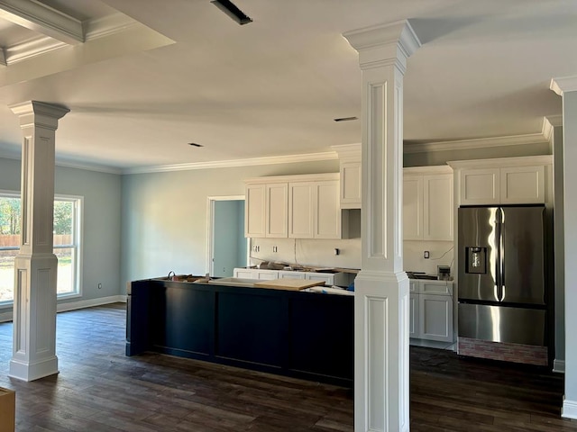 kitchen featuring decorative columns, dark hardwood / wood-style floors, white cabinets, and stainless steel fridge