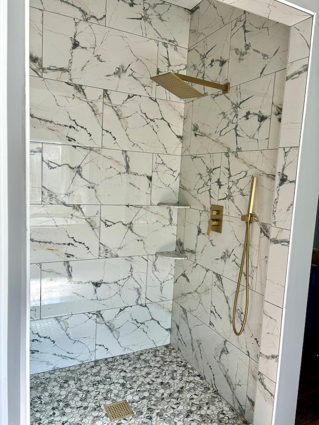 bathroom with a tile shower