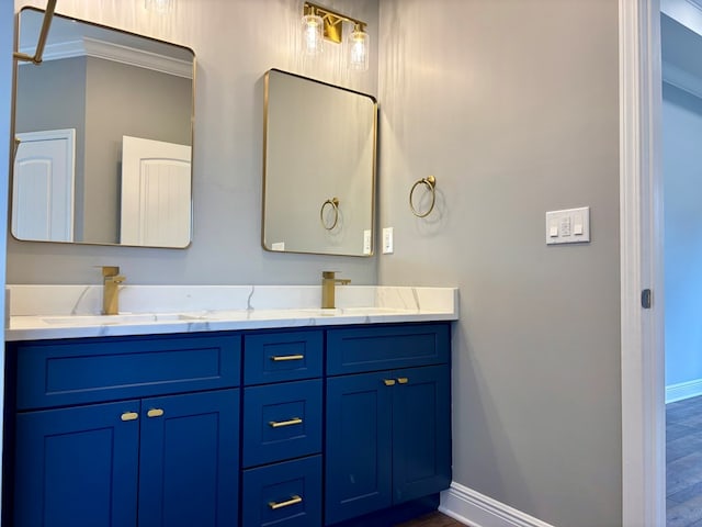 bathroom featuring crown molding, vanity, and wood-type flooring