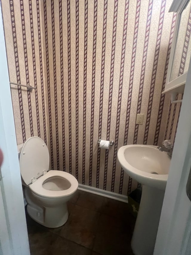 bathroom featuring tile patterned flooring and toilet