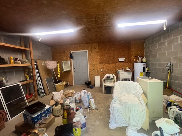 basement featuring water heater and sink