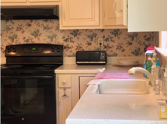 kitchen featuring extractor fan, sink, and black range with electric cooktop