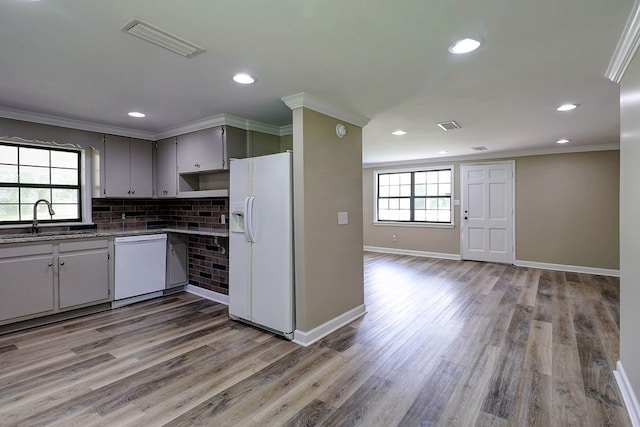 382 Timbers Dr, Dothan, AL 36301 - kitchen with white appliances, a sink, healthy amount of natural light, wood finished floors, and crown molding