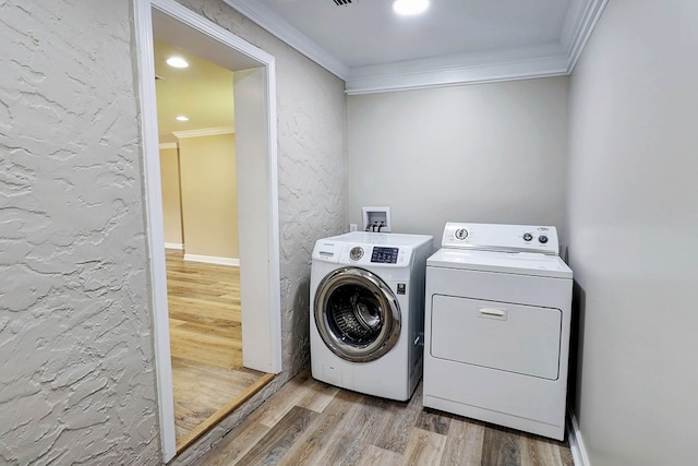 382 Timbers Dr, Dothan, AL 36301 - laundry area with washer and clothes dryer, ornamental molding, and light wood-type flooring