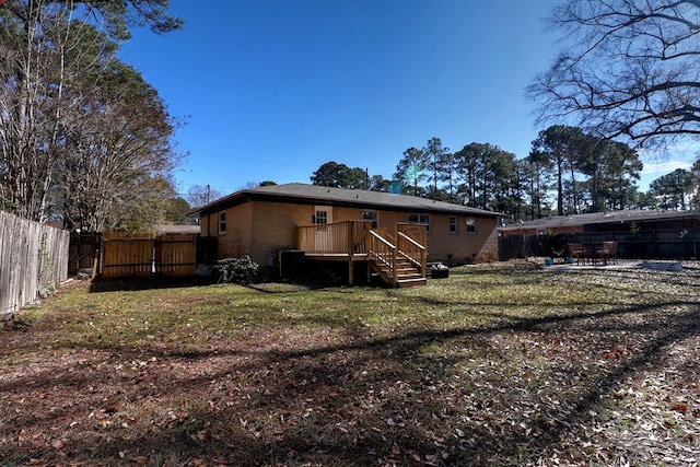 back of house with a lawn