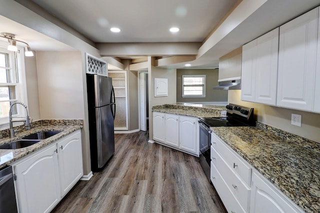 kitchen featuring appliances with stainless steel finishes, white cabinetry, sink, and hardwood / wood-style flooring