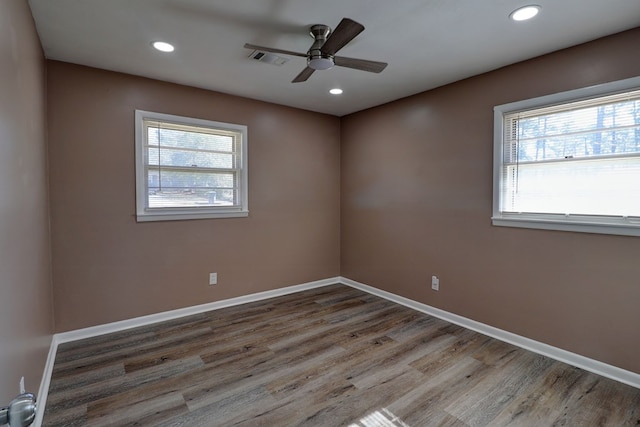 spare room with hardwood / wood-style floors and ceiling fan