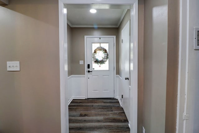 doorway to outside with crown molding and dark wood-type flooring