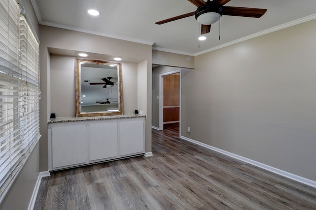 empty room featuring light hardwood / wood-style floors and crown molding