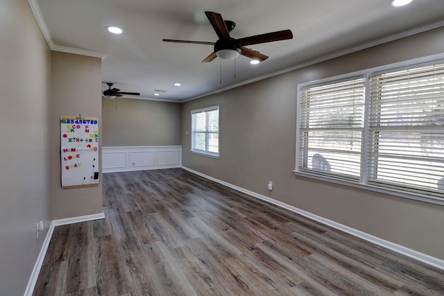 spare room featuring ceiling fan, ornamental molding, and dark hardwood / wood-style flooring