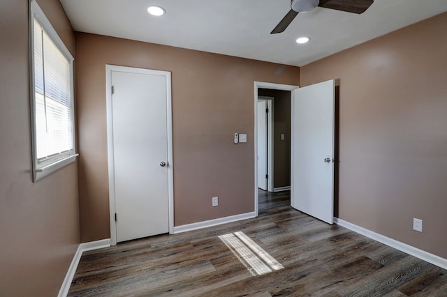 unfurnished bedroom featuring dark hardwood / wood-style flooring and ceiling fan