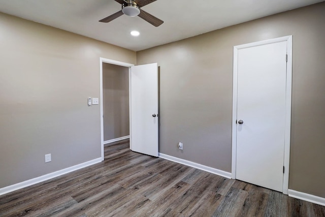 unfurnished bedroom featuring dark hardwood / wood-style flooring and ceiling fan