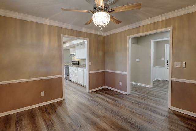 empty room with ceiling fan, light hardwood / wood-style floors, and crown molding