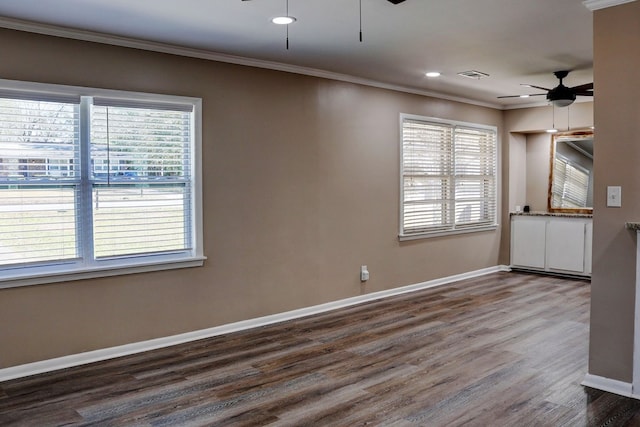 empty room featuring ceiling fan, crown molding, and hardwood / wood-style floors