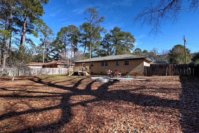 back of property featuring a patio and a deck