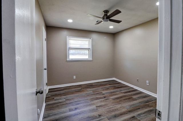 empty room with ceiling fan and dark wood-type flooring