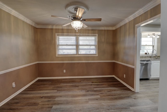 unfurnished dining area featuring ceiling fan, ornamental molding, light hardwood / wood-style floors, and sink