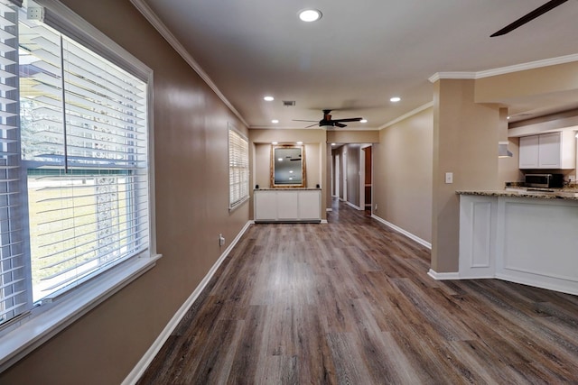 interior space featuring ceiling fan, ornamental molding, and wood-type flooring