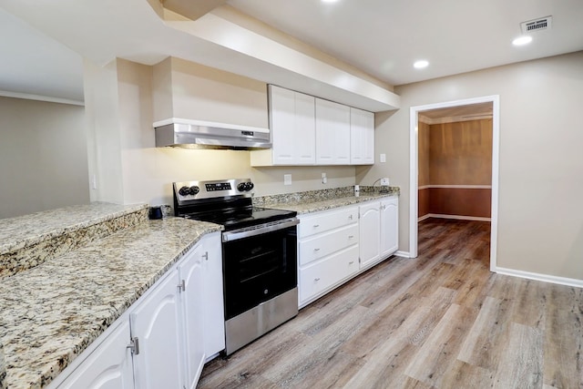 kitchen with range hood, white cabinets, electric stove, and light stone countertops