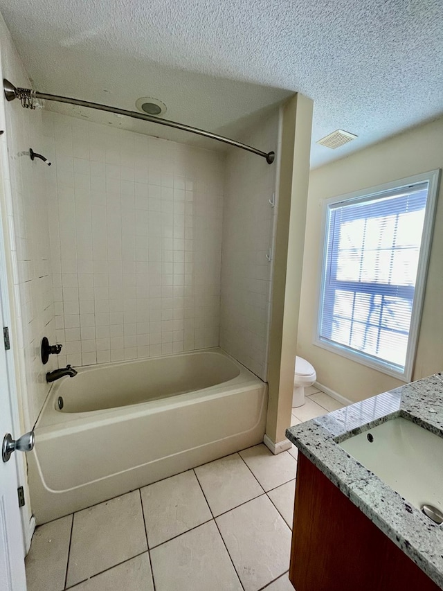 full bath featuring a textured ceiling, bathing tub / shower combination, vanity, and tile patterned flooring