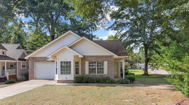 view of front of home with a front yard and a garage