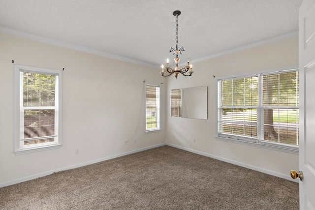 carpeted spare room featuring a chandelier, a textured ceiling, and crown molding