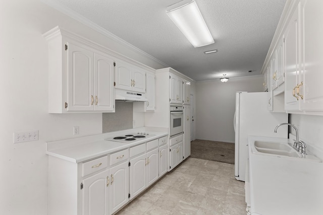 kitchen featuring white appliances, sink, ornamental molding, a textured ceiling, and white cabinetry