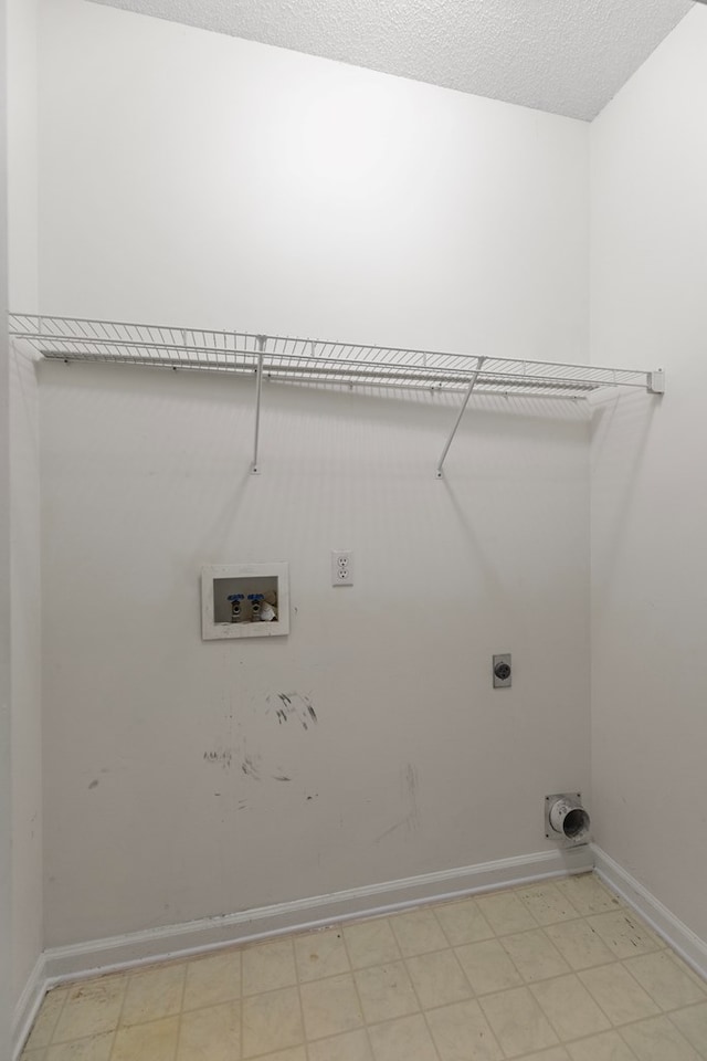 laundry room with electric dryer hookup, hookup for a washing machine, and a textured ceiling